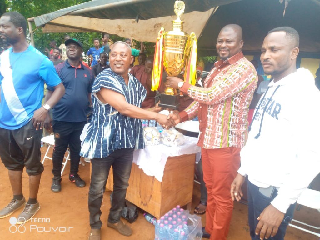 Wenchi MP, Seidu Haruna presenting a trophy to Okokyeredom Sarkodie Antwi and some of the Community teams